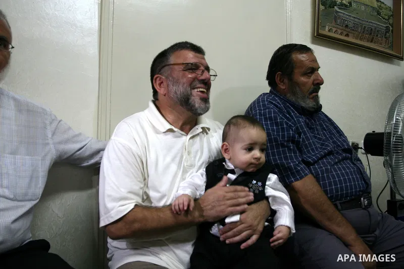 A Palestinian commander of the Hamas Islamist movement, Sheikh Hassan Yusef, 56, receives visitors in his home in the West Bank city of Ramallah after he was released from an Israeli jails, on Aug. 4, 2011. as Israel fre...