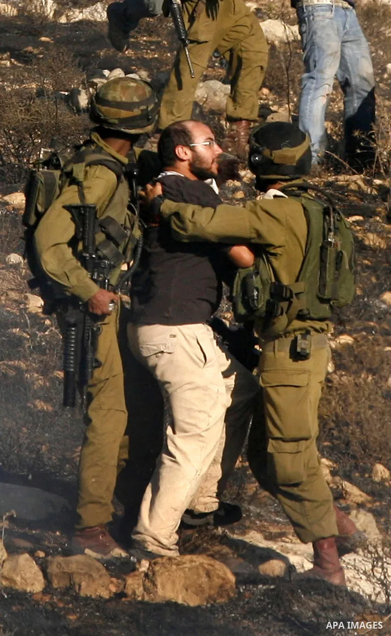 Israeli soldiers break up a fight between Jewish settlers and Palestinians over farming land between the Jewish settlement of Bracha and the nearby West Bank village of Burin, near Nablus, Thursday, Aug. 4, 2011.The IDF...