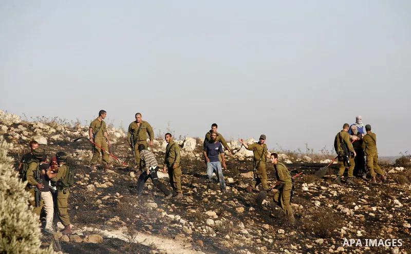 Israeli soldiers break up a fight between Jewish settlers and Palestinians over farming land between the Jewish settlement of Bracha and the nearby West Bank village of Burin, near Nablus, Thursday, Aug. 4, 2011.The IDF...