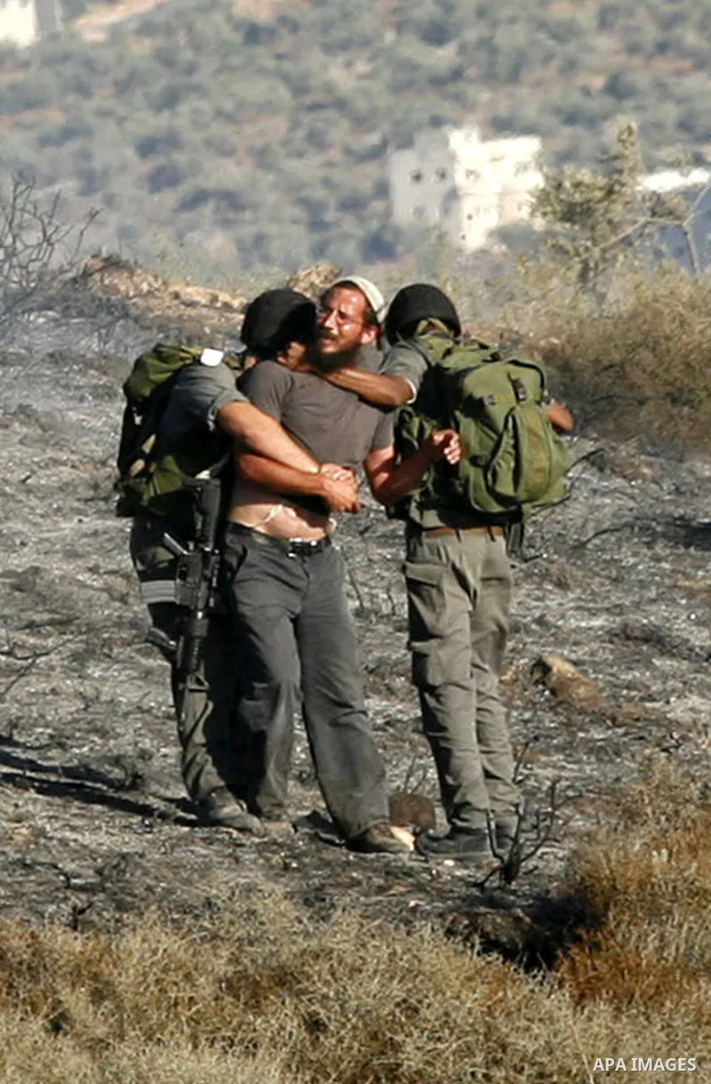 Israeli soldiers break up a fight between Jewish settlers and Palestinians over farming land between the Jewish settlement of Bracha and the nearby West Bank village of Burin, near Nablus, Thursday, Aug. 4, 2011.The IDF...
