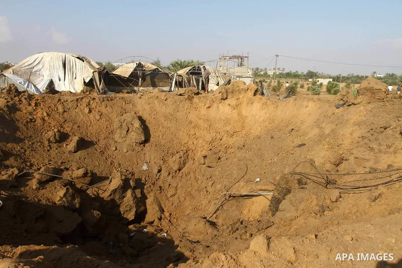 Palestinian man inspect the site of an Israeli overnight air raid in Dier al-Balah in the central of Gaza Strip on August 5, 2011. Israel's air force carried out three raids on the Gaza Strip without causing any casualti...