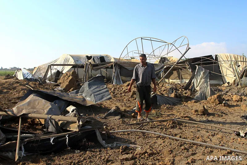 Palestinian man inspect the site of an Israeli overnight air raid in Dier al-Balah in the central of Gaza Strip on August 5, 2011. Israel's air force carried out three raids on the Gaza Strip without causing any casualti...