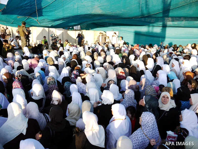 Palestinian women wait to cross the Qalandia checkpoint on their way to pray at the Al Aqsa Mosque on the first Friday of the Muslim holy month of Ramadan, at the Qalandia checkpoint between the West Bank city of Ramalla...