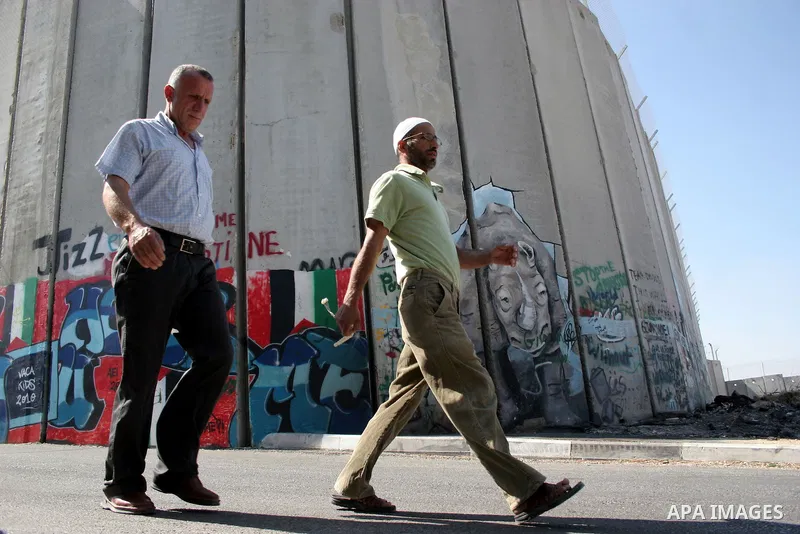 Palestinian worshippers walk in line to cross from the Qalandia checkpoint that leads from the West Bank town of Ramallah to Jerusalem on 05 August 2011, in order to attend the Friday prayers in the holy Muslim month of...