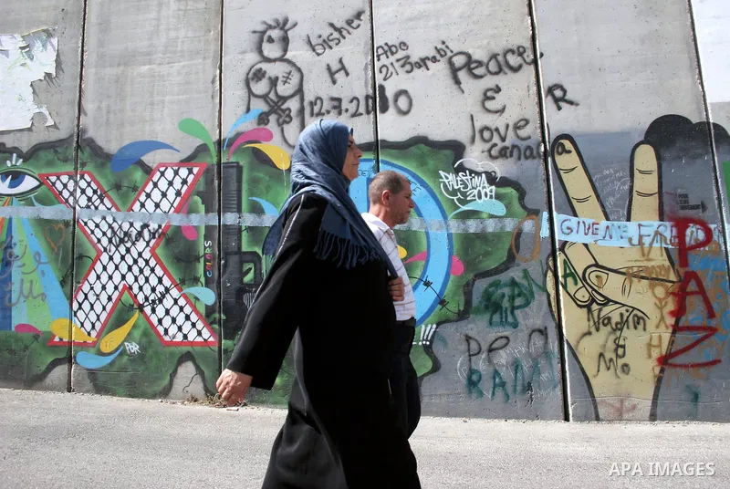 Palestinians walk in line to cross from the Qalandia checkpoint that leads from the West Bank town of Ramallah to Jerusalem on 05 August 2011, in order to attend the Friday prayers in the holy Muslim month of Ramadan at...