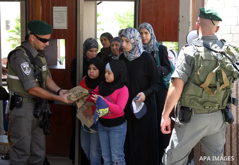 Palestinian women are being checked at an Israeli army checkpoint on her way to pray in the Ibrahimi Mosque in the West Bank city of Hebron, on Aug. 5, 2011. Muslims throughout the world are marking the month of Ramadan,...