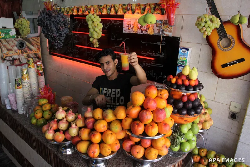 Palestinian vendor prepares different types of juice at his shop on the sixth day of the holy month of Ramadan in Gaza City on Aug. 6, 2011 . Muslims all over the world fast from dawn to dusk during the holy month of Ram...