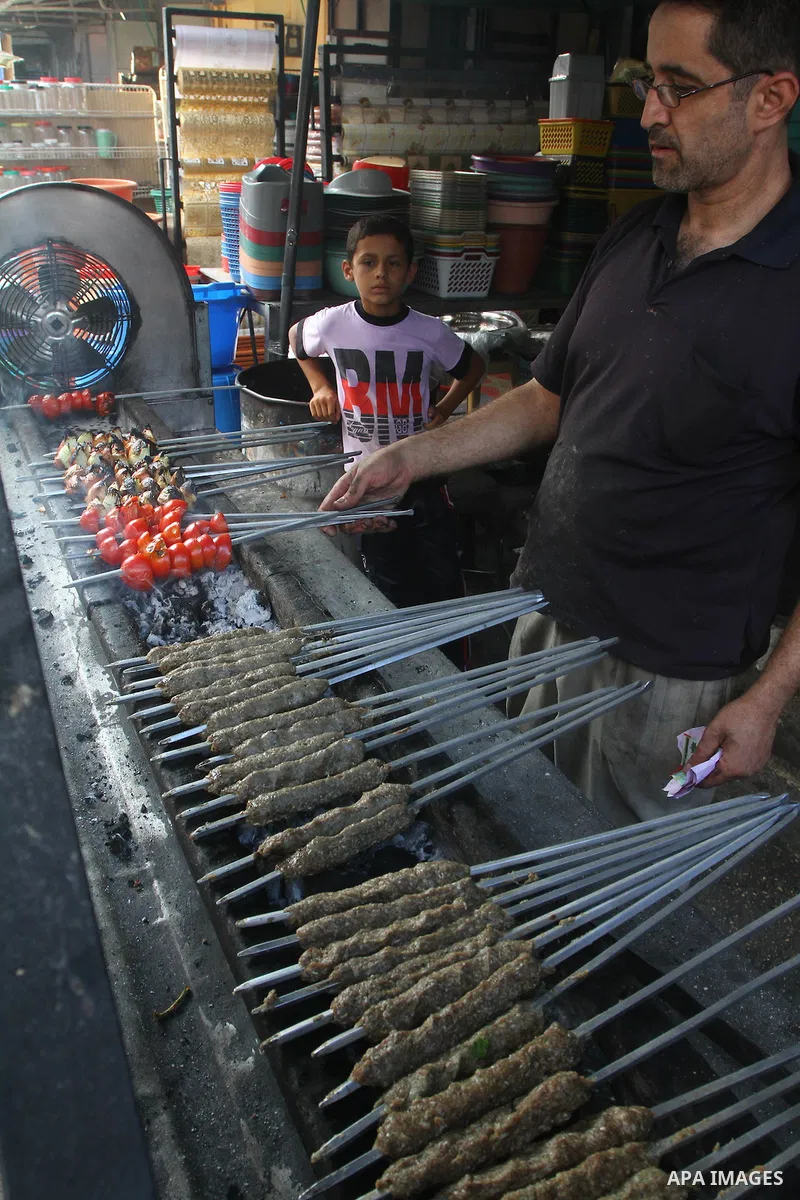 A Palestinian vendor sells grilled meat "Kebabs" in his shop at a market in Gaza city on Aug. 6, 2011. Muslims around the world abstain from eating, drinking and conducting sexual relations from sunrise to sunset during...