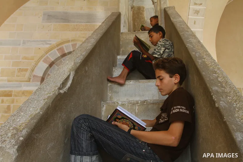 Palestinian boys read the holy Koran at al-Omari Mosque in Gaza city, during the Muslim holy fasting month of Ramadan, on Aug. 6, 2011. Muslims throughout the world are celebrating the holy fasting month of Ramadan, the...