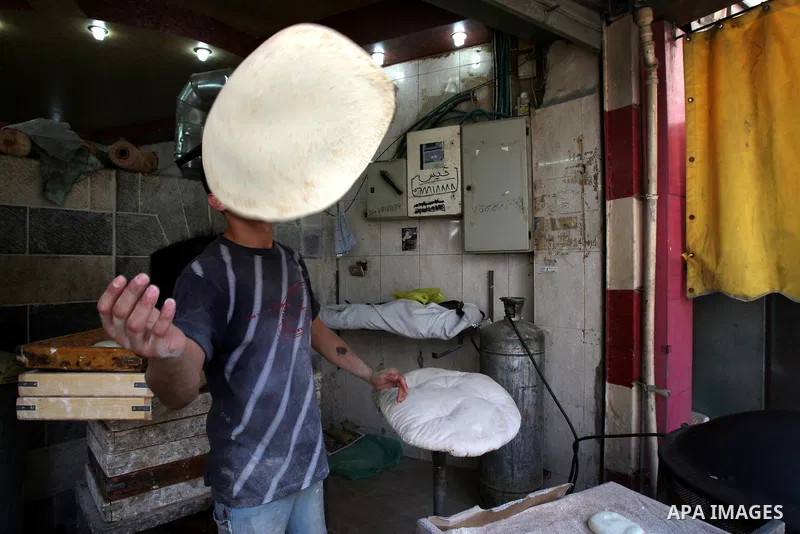 A Palestinian vendor bakes traditional bread on a fasting day of Ramadan in his shop in the West Bank city of Nablus on Aug. 7, 2011. Muslims around the world abstain from eating, drinking and conducting sexual intercour...