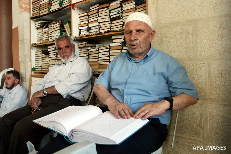 A Palestinian old man, Abdel Fattah Mubarak, 67 years, reads the holy koran in Braille at a Mosque in the West Bank city of Ramallah, on Aug. 7, 2011. Muslims around the world are observing the holy fasting month of Rama...