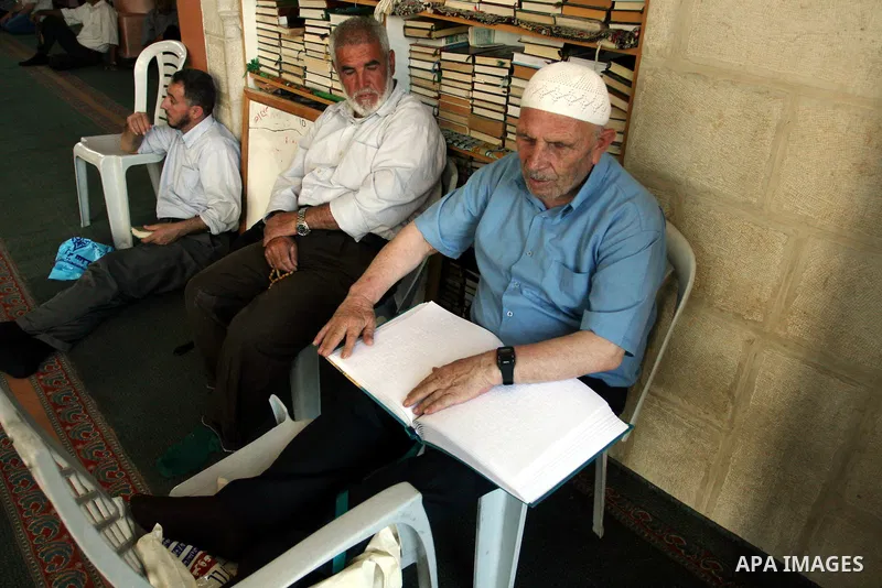 A Palestinian old man, Abdel Fattah Mubarak, 67 years, reads the holy koran in Braille at a Mosque in the West Bank city of Ramallah, on Aug. 7, 2011. Muslims around the world are observing the holy fasting month of Rama...