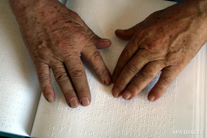 A Palestinian old man, Abdel Fattah Mubarak, 67 years, reads the holy koran in Braille at a Mosque in the West Bank city of Ramallah, on Aug. 7, 2011. Muslims around the world are observing the holy fasting month of Rama...