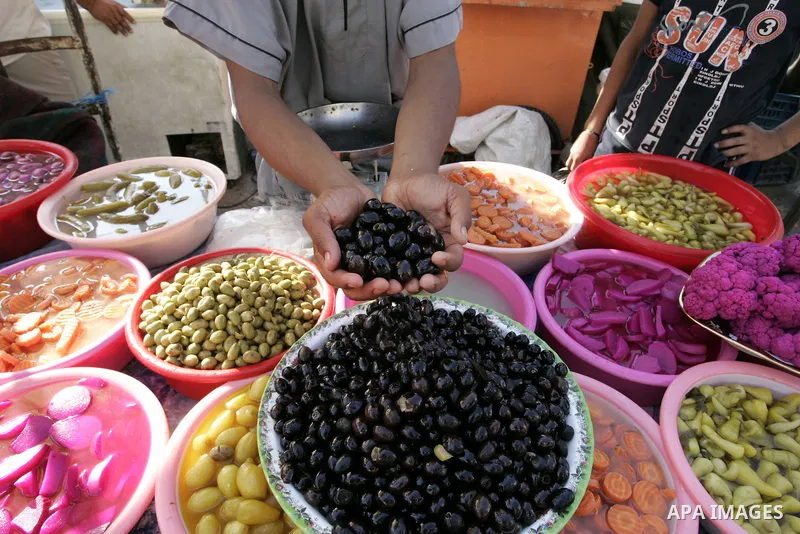 A Palestinian vendor sells pickles at a market in Rafah, southern Gaza Strip on Aug. 7, 2011. Muslims around the world abstain from eating, drinking and conducting sexual relations from sunrise to sunset during Ramadan,...