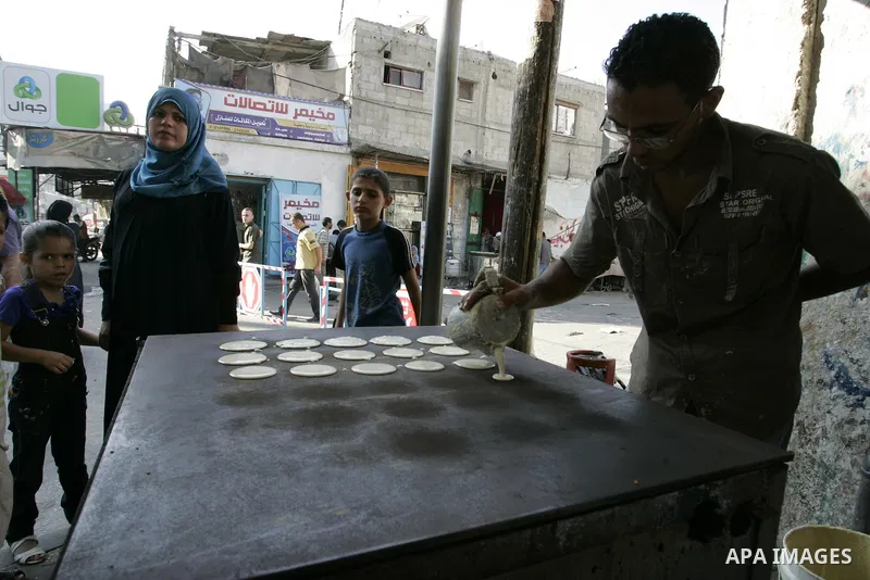 A Palestinian vendor prepares qatayef, a traditional pancake for Ramadan, at a shop in Rafah, southern Gaza Strip on Aug. 7, 2011. Muslims around the world abstain from eating, drinking and conducting sexual relations fr...