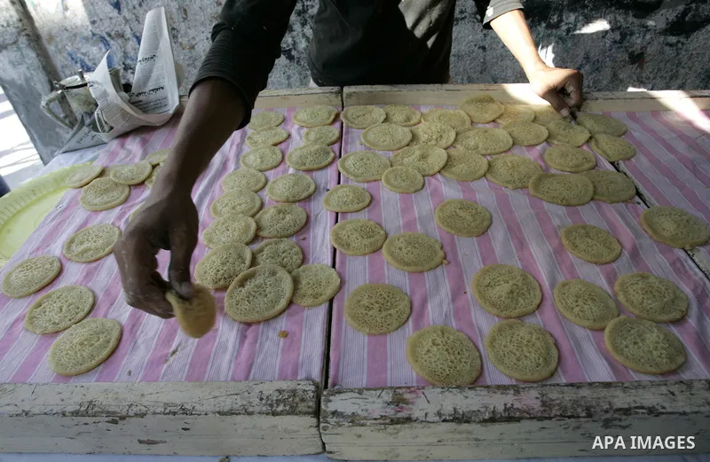 A Palestinian vendor prepares qatayef, a traditional pancake for Ramadan, at a shop in Rafah, southern Gaza Strip on Aug. 7, 2011. Muslims around the world abstain from eating, drinking and conducting sexual relations fr...