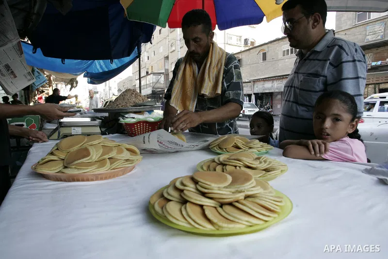 A Palestinian vendor prepares qatayef, a traditional pancake for Ramadan, at a shop in Rafah, southern Gaza Strip on Aug. 7, 2011. Muslims around the world abstain from eating, drinking and conducting sexual relations fr...