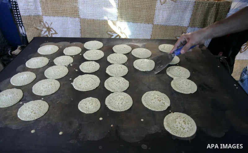 A Palestinian vendor prepares qatayef, a traditional pancake for Ramadan, at a shop in Rafah, southern Gaza Strip on Aug. 7, 2011. Muslims around the world abstain from eating, drinking and conducting sexual relations fr...