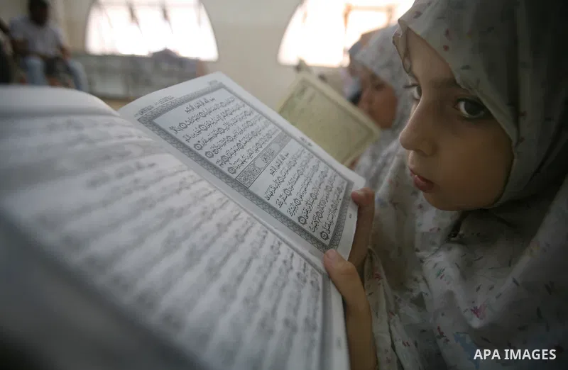 Palestinian Muslim girls read the holy Koran during a mass Koran reading session at a mosque in Gaza City, Gaza Strip, 07 August 2011. Muslims around the world are observing the fasting month of Ramadan during which they...