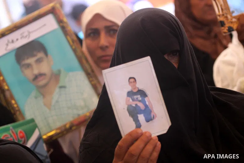 Palestinian women hold pictures of their prisoned relatives in Israeli jails as they gather in a weekly activity calling for their liberty at the Red Cross headquarters in Gaza City on Aug. 8, 2011. About 7000 prisoners...
