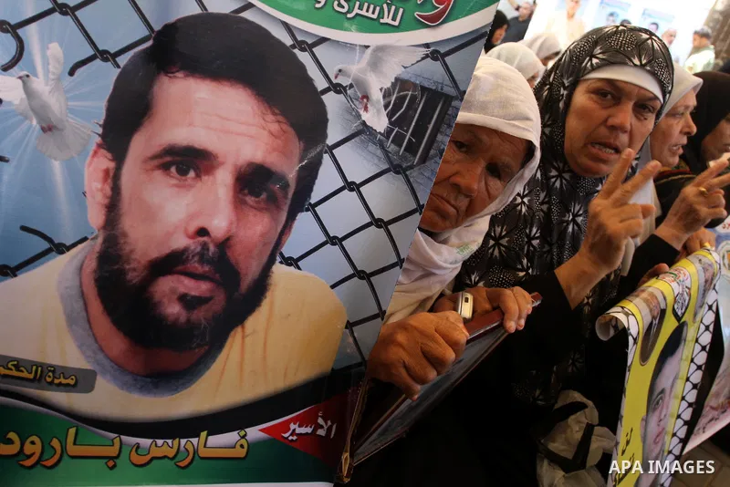 Palestinian women hold pictures of their prisoned relatives in Israeli jails as they gather in a weekly activity calling for their liberty at the Red Cross headquarters in Gaza City on Aug. 8, 2011. About 7000 prisoners...