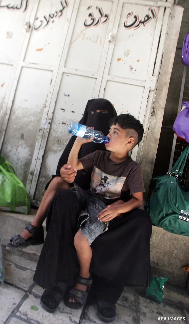 A Palestinian poor woman, sits on the floor asking for money at a market in the holiest month of Ramadan in the old city of Jerusalem on Aug. 8, 2011. Muslims throughout the world are marking the month of Ramadan, during...