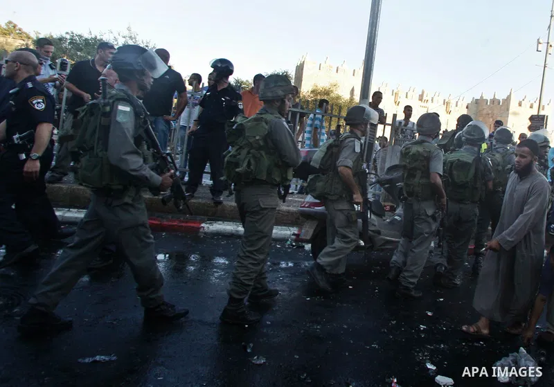 Israeli border guard keep watch Palestinians as they shop at a market, in the old city of Jerusalem on Aug. 8, 2011. Muslims throughout the world are marking the month of Ramadan, during which they refrain from eating, d...