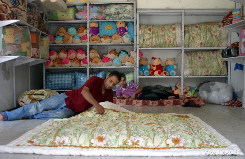 A Palestinian vendor works in his shop in the West Bank city of Hebron on Aug. 8, 2011. Muslims around the world abstain from eating, drinking and conducting sexual relations from sunrise to sunset during Ramadan, the ho...