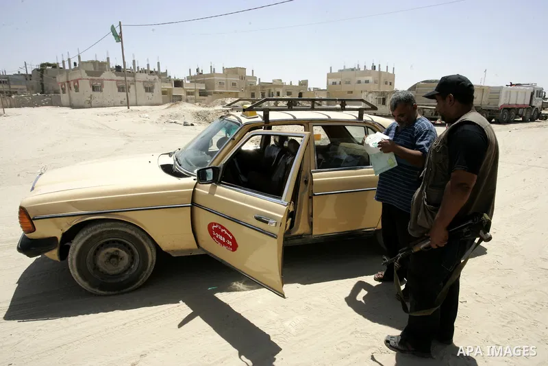 A Palestinian Hamas policeman during searching cars near the tunnels between Egypt and Gaza border, in part of a campaign to search vehicles, in Rafah, southern Gaza Strip on Aug. 8, 2011. Photo by Abed Rahim Khatib