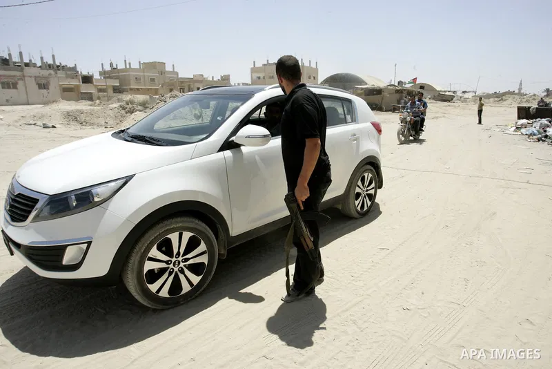 A Palestinian Hamas policeman during searching cars near the tunnels between Egypt and Gaza border, in part of a campaign to search vehicles, in Rafah, southern Gaza Strip on Aug. 8, 2011. Photo by Abed Rahim Khatib