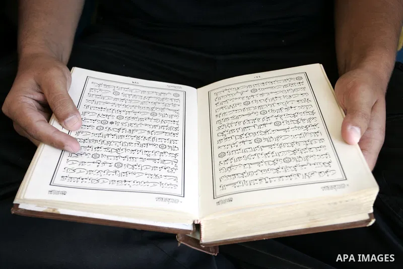 A Palestinian Hamas policeman reads the holy Koran near the tunnels between Egypt and Gaza border in Rafah, southern Gaza Strip on Aug. 8, 2011. Muslims around the world refrain from eating, drinking and sexual intercour...