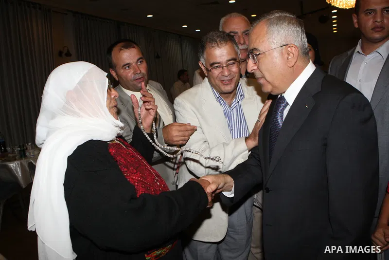 Palestinian Prime Minister Salam Fayyad, participates in the annual Ramadan breakfast for prisoners and families of the martyrs on Aug 8, 2011. Photo by Mustafa Abu Dayeh