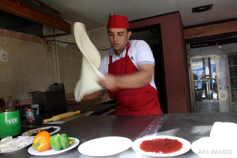 A Palestinian chef prepares Pastry or "Fatayer" with municipal ghee on a new forms at Colonel restaurant in Gaza city on Aug. 9, 2011, where prepare many forms such as pastry pizza, apple pie and pastry pillow. Muslims a...