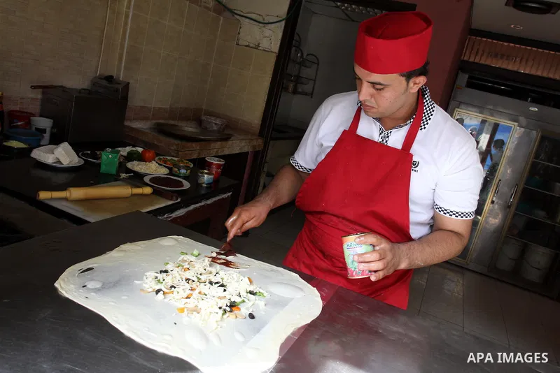 A Palestinian chef prepares Pastry or "Fatayer" with municipal ghee on a new forms at Colonel restaurant in Gaza city on Aug. 9, 2011, where prepare many forms such as pastry pizza, apple pie and pastry pillow. Muslims a...