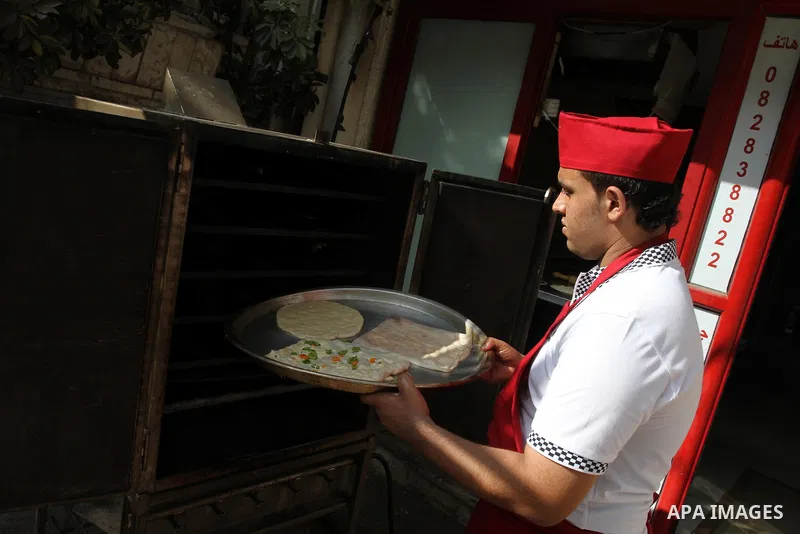 A Palestinian chef prepares Pastry or "Fatayer" with municipal ghee on a new forms at Colonel restaurant in Gaza city on Aug. 9, 2011, where prepare many forms such as pastry pizza, apple pie and pastry pillow. Muslims a...