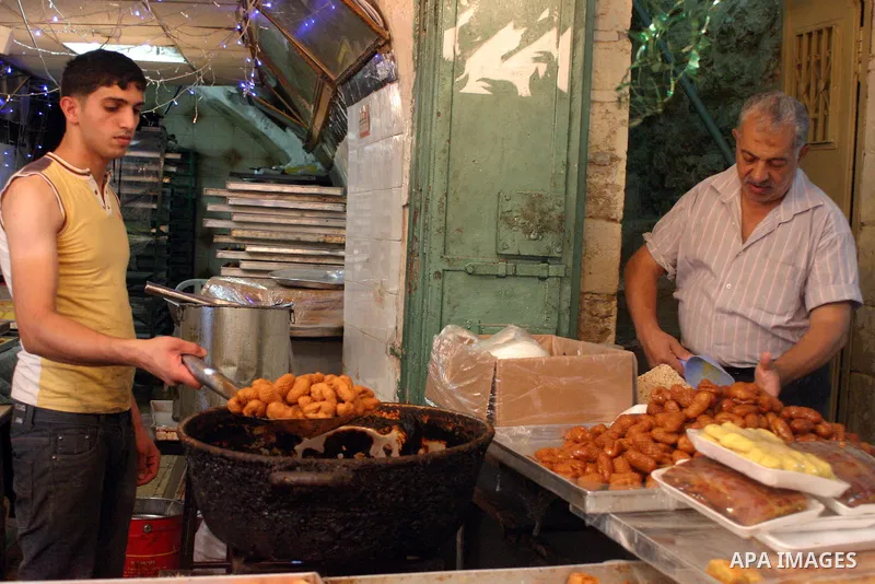 A Palestinian worker prepares traditional sweets popular during the Muslim holy month of Ramadan in the West Bank city of Hebron Aug. 9, 2011. Muslims around the world abstain from eating, drinking and conducting sexual...