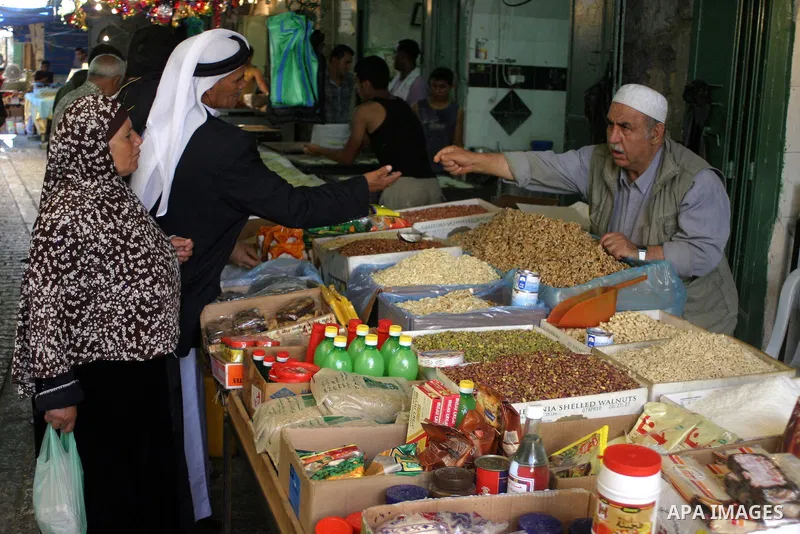 Palestinians shop for food at a market in the West Bank city of Hebron August 9, 2011. Muslims around the world abstain from eating, drinking and conducting sexual relations from sunrise to sunset during Ramadan, the hol...