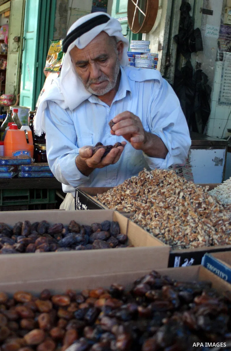 A Palestinian vendor sells dates in his shop in the West Bank city of Hebron Aug. 9, 2011. Muslims around the world abstain from eating, drinking and conducting sexual relations from sunrise to sunset during Ramadan, the...