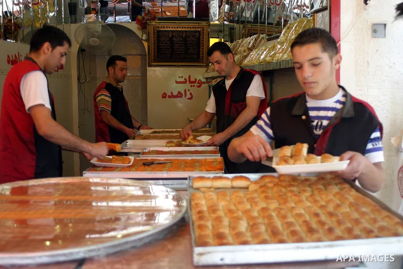 A Palestinian worker displays traditional sweets popular during the Muslim holy month of Ramadan in the West Bank city of Hebron Aug. 9, 2011. Muslims around the world abstain from eating, drinking and conducting sexual...