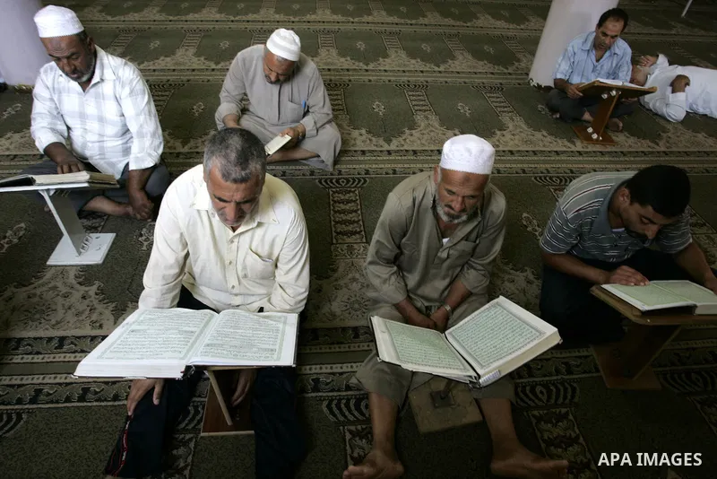 Palestinian Muslims read the holy Koran at a Mosque in Rafah, southern Gaza Strip on Aug. 9, 2011. Muslims around the world refrain from eating, drinking and sexual intercourse from dawn till dusk during Ramadan, the hol...