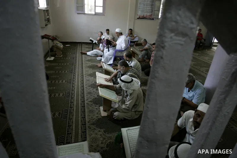 Palestinian Muslims read the holy Koran at a Mosque in Rafah, southern Gaza Strip on Aug. 9, 2011. Muslims around the world refrain from eating, drinking and sexual intercourse from dawn till dusk during Ramadan, the hol...