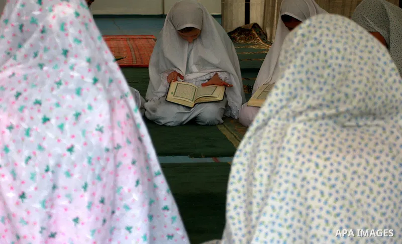 Palestinian girls read the holy Koran during the Muslim holy fasting month of Ramadan at a mosque in Balata refugee camp in the West Bank city of Nablus on Aug. 9, 2011. Muslims around the world are observing the holy fa...
