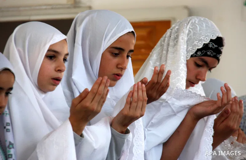 Palestinian girls read the holy Koran during the Muslim holy fasting month of Ramadan at a mosque in Balata refugee camp in the West Bank city of Nablus on Aug. 9, 2011. Muslims around the world are observing the holy fa...