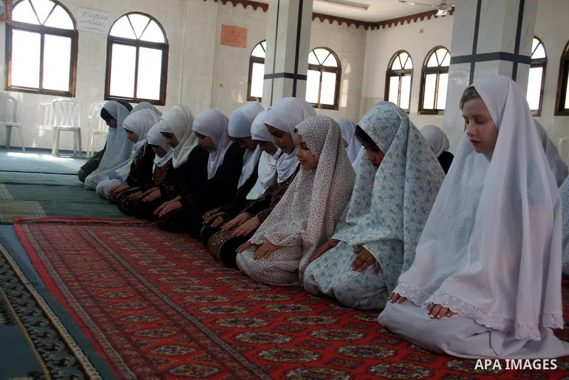 Palestinian girls read the holy Koran during the Muslim holy fasting month of Ramadan at a mosque in Balata refugee camp in the West Bank city of Nablus on Aug. 9, 2011. Muslims around the world are observing the holy fa...