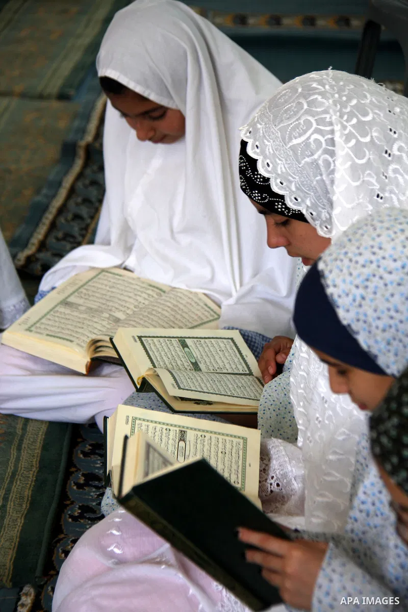 Palestinian girls read the holy Koran during the Muslim holy fasting month of Ramadan at a mosque in Balata refugee camp in the West Bank city of Nablus on Aug. 9, 2011. Muslims around the world are observing the holy fa...