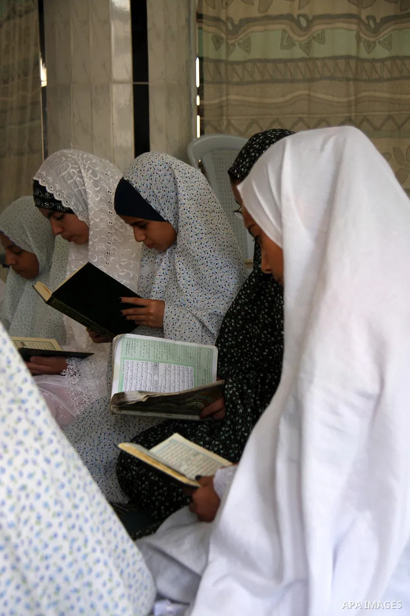 Palestinian girls read the holy Koran during the Muslim holy fasting month of Ramadan at a mosque in Balata refugee camp in the West Bank city of Nablus on Aug. 9, 2011. Muslims around the world are observing the holy fa...