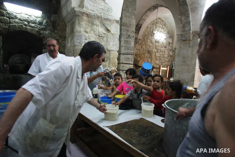 Palestinian children receive food rations on August 9,2011 distributed by the Waqf, a Jordanian-backed body that oversees Muslim holy sites in Jerusalem, on the second week of the fasting month of Ramadan in Jerusalem's...
