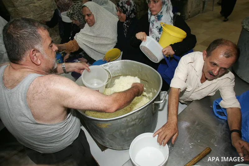 Palestinian children receive food rations on August 9,2011 distributed by the Waqf, a Jordanian-backed body that oversees Muslim holy sites in Jerusalem, on the second week of the fasting month of Ramadan in Jerusalem's...