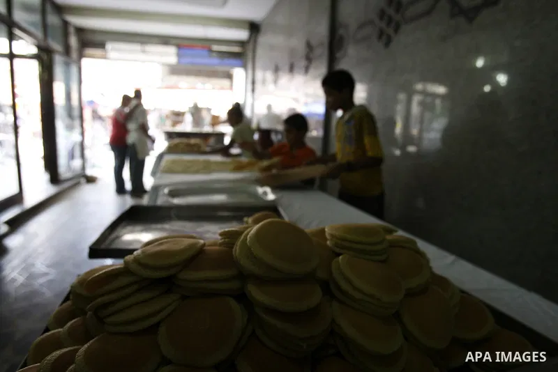 Palestinian boys prepare qatayef, a popular sweet to sell it during Ramadan, at a shop in Gaza city on Aug.10, 2011. Muslims around the world are observing the holy fasting month of Ramadan where they refrain from eating...