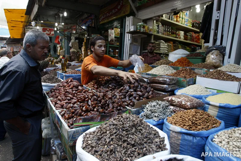 A Palestinian vendor sells dates in his shop at a market in Gaza city Aug. 10, 2011. Muslims around the world abstain from eating, drinking and conducting sexual relations from sunrise to sunset during Ramadan, the holie...